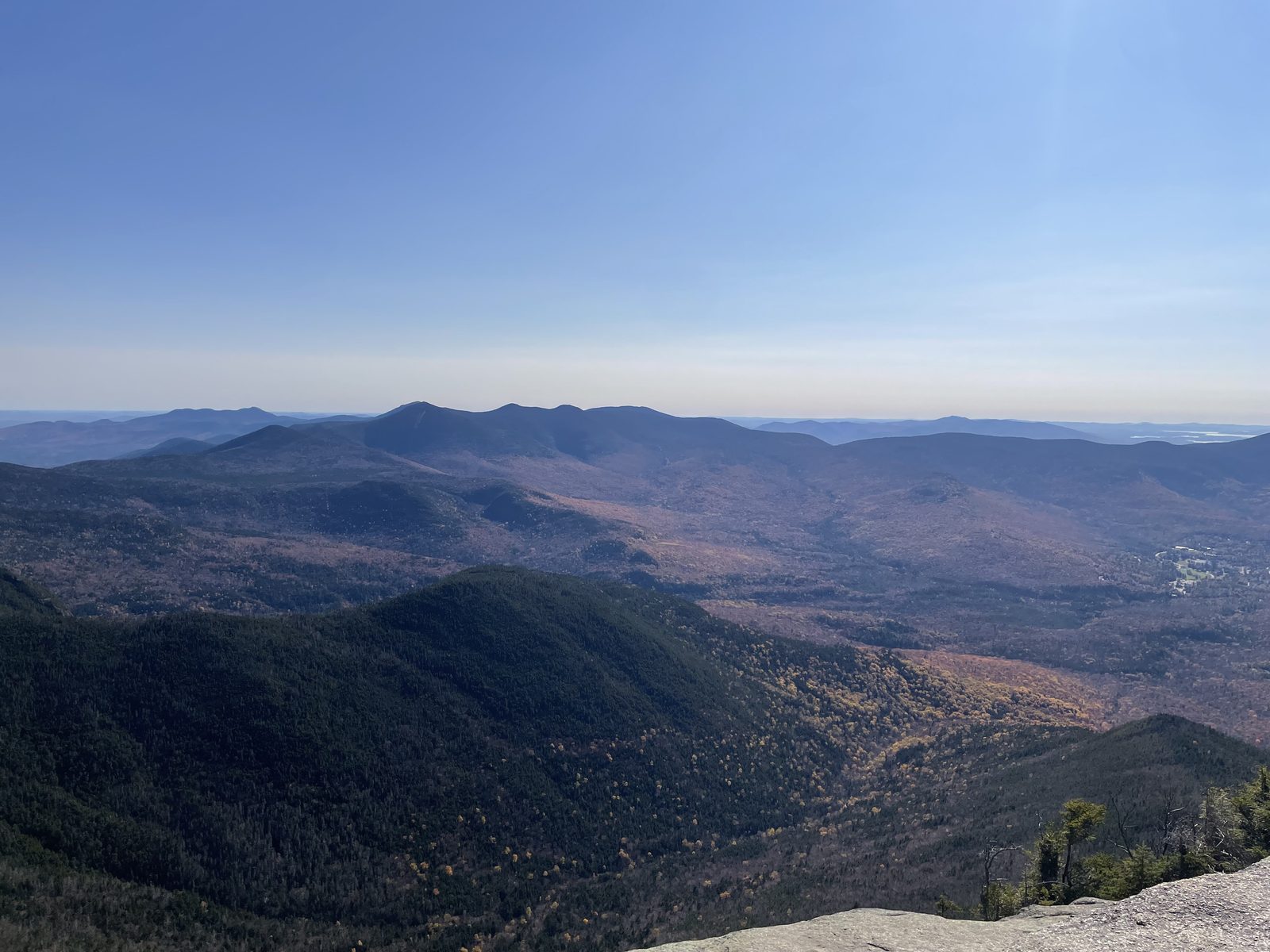 Rolling mountain ranges with autumn colors under a clear sky